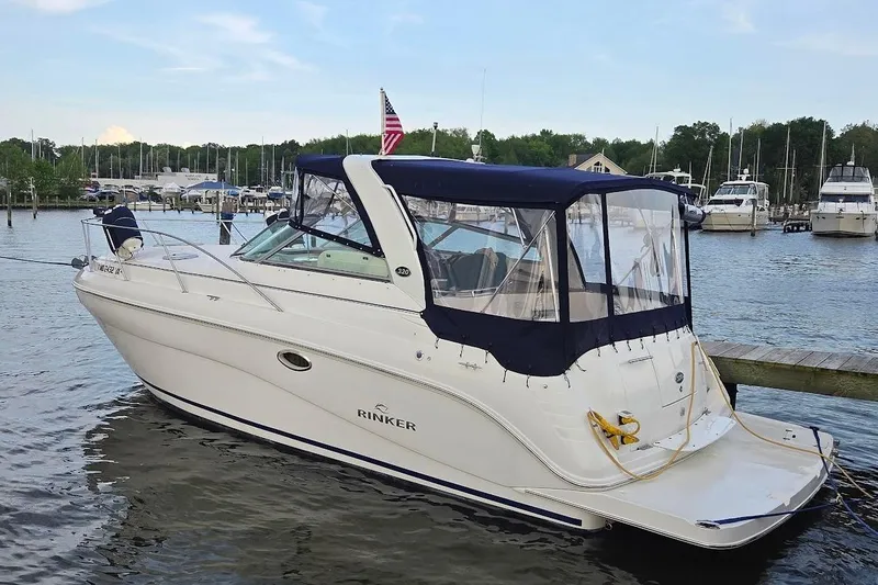 Slide: The Image of 2007 Rinker 320 Express Cruiser docked at a marina, featuring a navy canopy. - 5