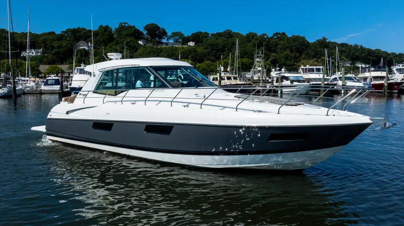 The Image of 2013 Cruisers Yachts 48 Cantius in marina, sleek design, calm waters, sunny day. - 0