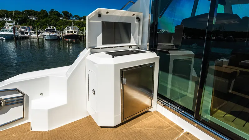 Slide: The Image of Outdoor kitchen area on 2013 Cruisers Yachts 48 Cantius, featuring stainless steel appliances. - 16