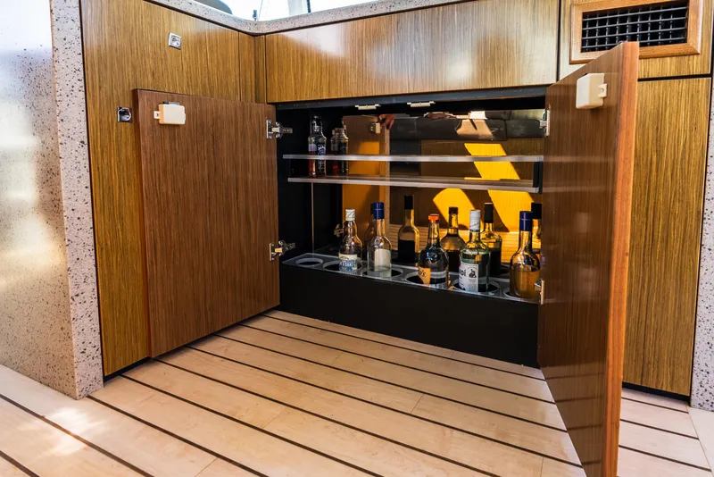 Slide: The Image of Luxurious bar cabinet on 2013 Cruisers Yachts 48 Cantius, featuring various liquor bottles. - 20