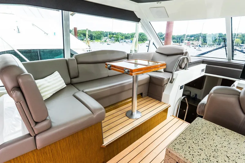 Slide: The Image of Luxurious interior of 2013 Cruisers Yachts 48 Cantius with plush seating and elegant table. - 23