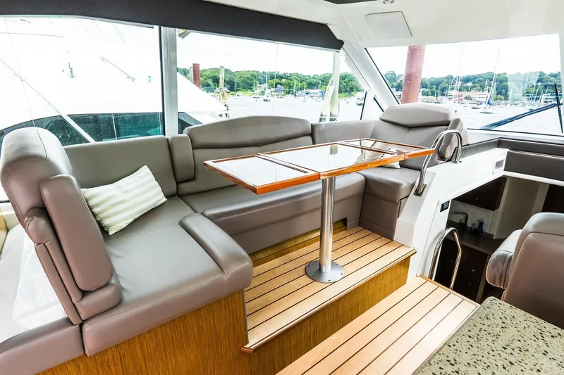 Slide: The Image of Luxurious interior of 2013 Cruisers Yachts 48 Cantius with plush seating and wooden table. - 24
