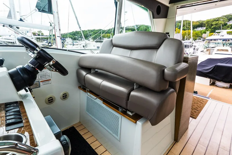 Slide: The Image of Luxurious helm seat on 2013 Cruisers Yachts 48 Cantius, featuring sleek design and comfort. - 26