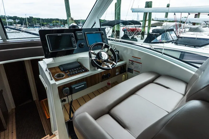 Slide: The Image of Helm of 2013 Cruisers Yachts 48 Cantius with modern navigation equipment and comfortable seating. - 27