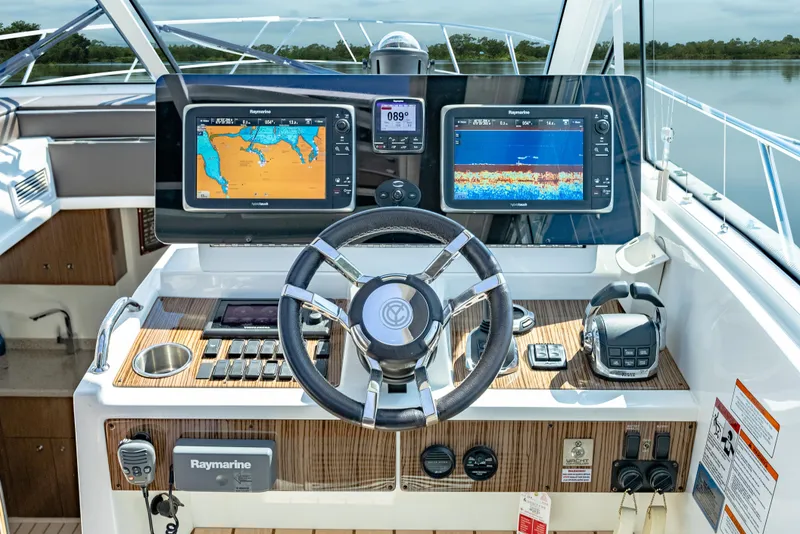 Slide: The Image of Helm of 2013 Cruisers Yachts 48 Cantius with navigation displays and controls. - 28