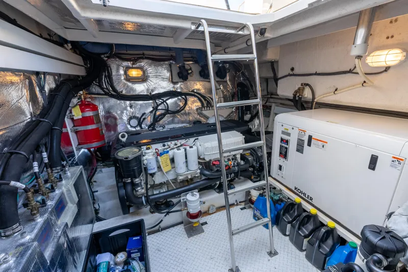 Slide: The Image of Engine room of 2013 Cruisers Yachts 48 Cantius with equipment and ladder. - 44
