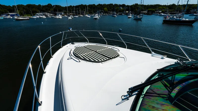 Slide: The Image of Bow view of 2013 Cruisers Yachts 48 Cantius in a marina setting. - 48