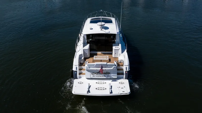 Slide: The Image of 2013 Cruisers Yachts 48 Cantius on water, rear view, sleek design, luxury motor yacht. - 8