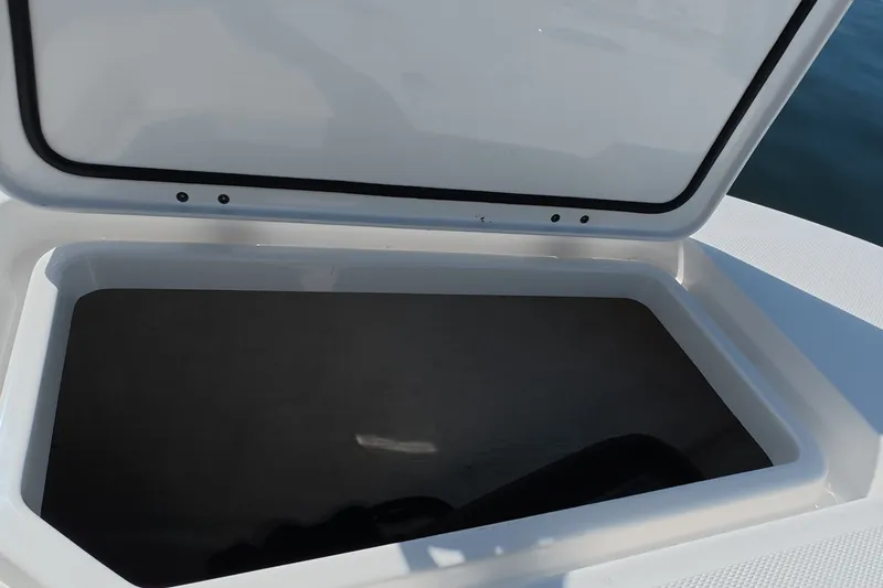 Slide: The Image of Open storage compartment on 2023 Invincible 33 Catamaran boat, showcasing interior space. - 25