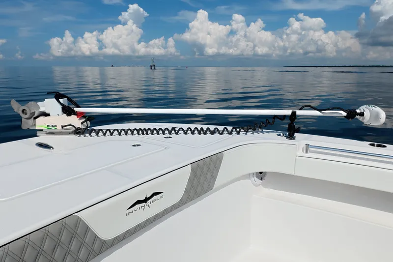 Slide: The Image of 2023 Invincible 33 Catamaran on calm ocean with clear skies and clouds. - 36