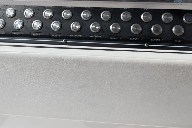 Slide: The Image of Control panel of 2023 Invincible 33 Catamaran with labeled buttons for bilge and baitwell. - 19