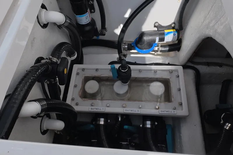 Slide: The Image of Baitwell system in 2023 Invincible 33 Catamaran, featuring multiple hoses and valves. - 27