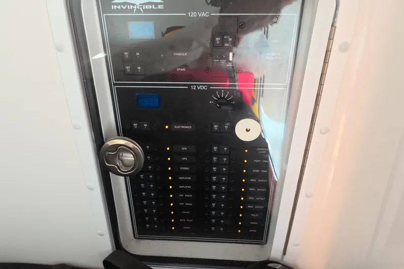 Slide: The Image of Control panel of 2023 Invincible 33 Catamaran, featuring switches and indicators. - 35