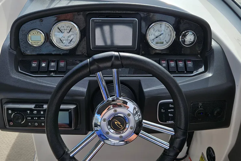 Slide: The Image of Steering console of 2010 Regal 2700 ES Bowrider with gauges and controls. - 10