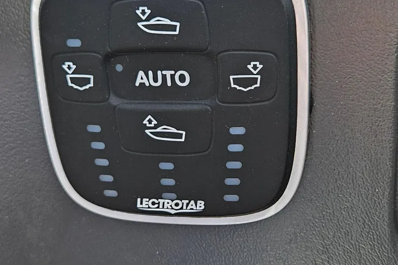 Slide: The Image of Control panel of a 2010 Regal 2700 ES Bowrider boat with Lectrotab system. - 11