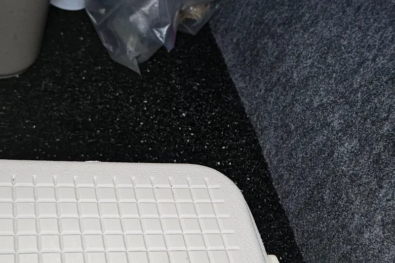 Slide: The Image of Interior of 2010 Regal 2700 ES Bowrider with textured flooring and storage compartment. - 17