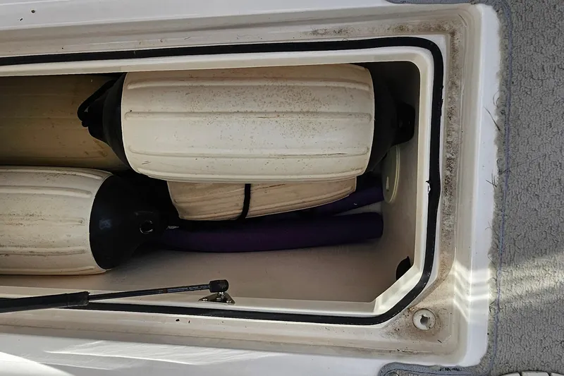 Slide: The Image of Storage compartment of 2010 Regal 2700 ES Bowrider with boat fenders inside. - 23