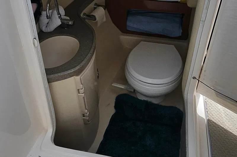 Slide: The Image of Interior of a 2010 Regal 2700 ES Bowrider boat bathroom with sink and toilet. - 25