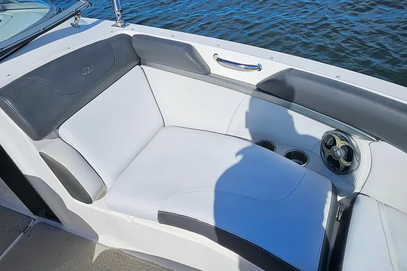 Slide: The Image of 2010 Regal 2700 ES Bowrider interior seating with cup holders and speaker, on water. - 30