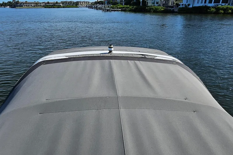 Slide: The Image of 2010 Regal 2700 ES Bowrider with cover on calm water. - 33