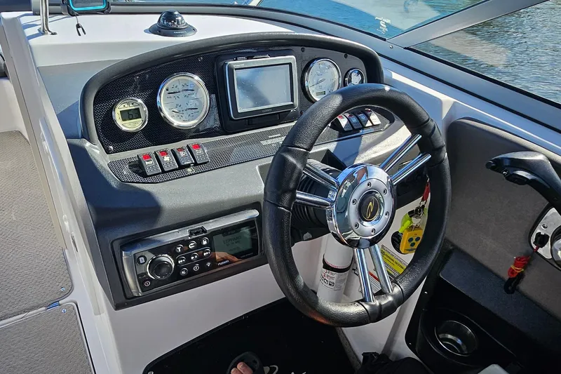 Slide: The Image of 2010 Regal 2700 ES Bowrider dashboard with steering wheel and control panel. - 38