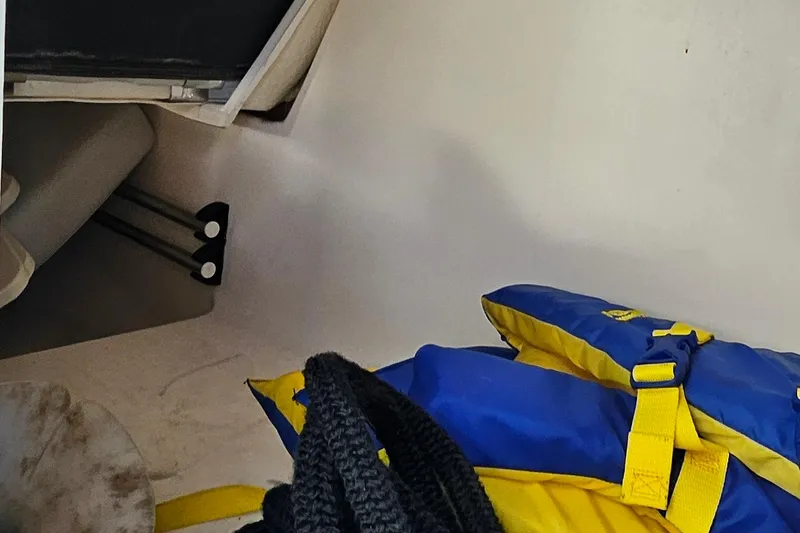 Slide: The Image of Interior of 2010 Regal 2700 ES Bowrider with life jackets and storage area. - 42