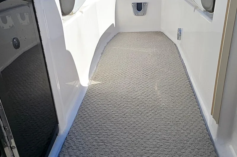 Slide: The Image of Interior walkway of a 2010 Regal 2700 ES Bowrider with carpet flooring. - 44