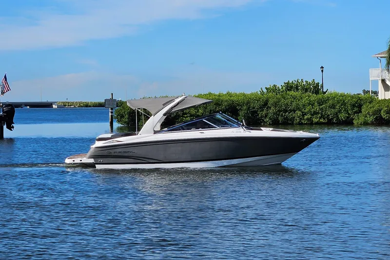 Slide: The Image of 2010 Regal 2700 ES Bowrider cruising on a sunny day in a scenic waterway. - 47