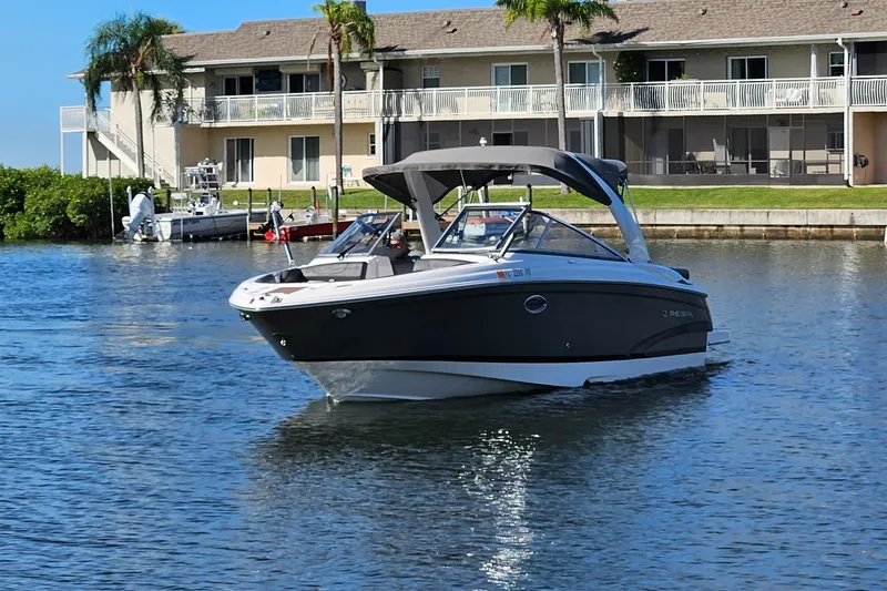 Slide: The Image of 2010 Regal 2700 ES Bowrider on water near waterfront homes, sunny day. - 53