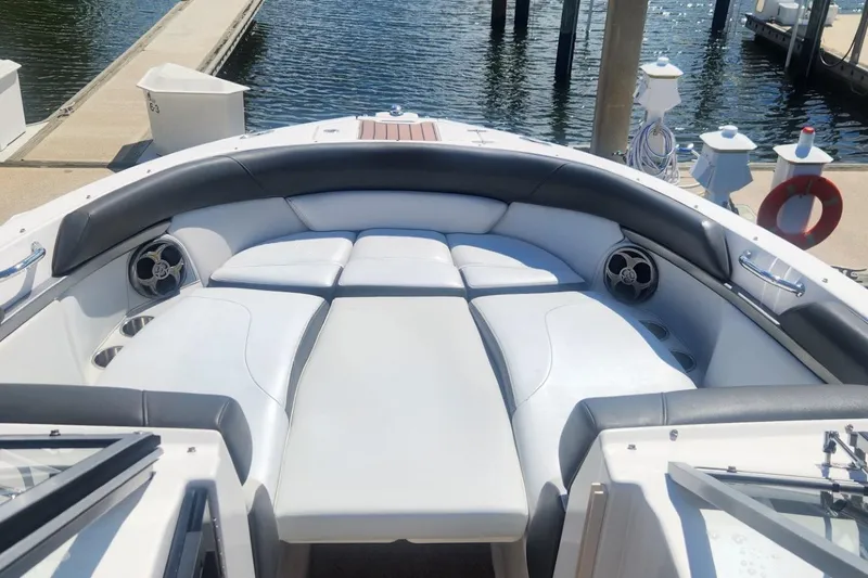 Slide: The Image of 2010 Regal 2700 ES Bowrider with spacious seating, docked at a marina. - 6