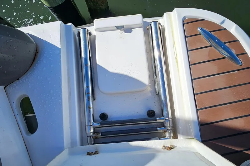 Slide: The Image of 2010 Regal 2700 ES Bowrider swim platform with ladder and teak-style decking. - 64