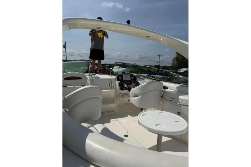 Slide: The Image of 2001 Formula 290 Sun Sport boat interior with white seating and small table. - 3