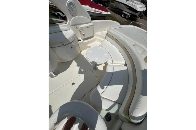 Slide: The Image of 2001 Formula 290 Sun Sport boat interior with white seating and small table. - 4