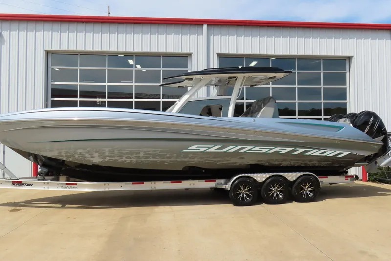 The Image of 2020 Sunsation 34 CCX boat on trailer, parked outside a garage. - 0