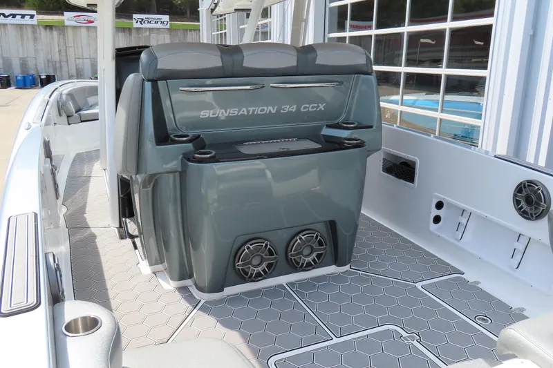 Slide: The Image of 2020 Sunsation 34 CCX boat interior with seating and speakers, showcasing modern design. - 10