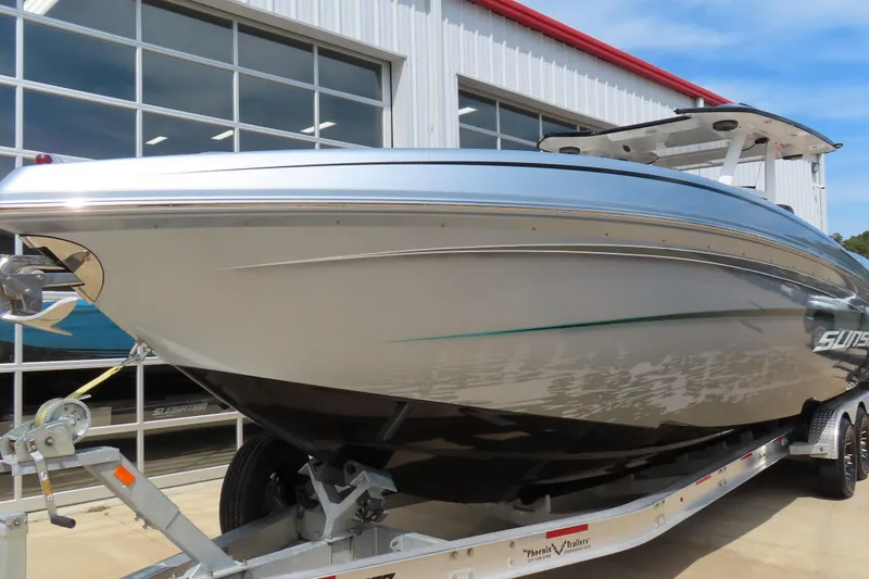 Slide: The Image of 2020 Sunsation 34 CCX boat on trailer, parked outside a building. - 2