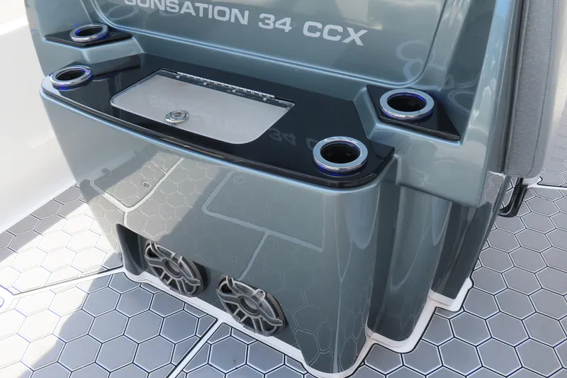 Slide: The Image of 2020 Sunsation 34 CCX boat console with cup holders and hexagonal flooring. - 21