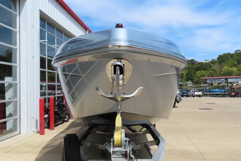 Slide: The Image of 2020 Sunsation 34 CCX boat on trailer outside a building, clear sky background. - 3