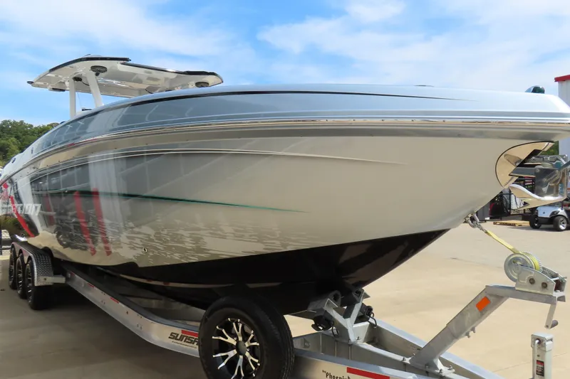 Slide: The Image of 2020 Sunsation 34 CCX boat on trailer, sleek design, parked outdoors. - 4
