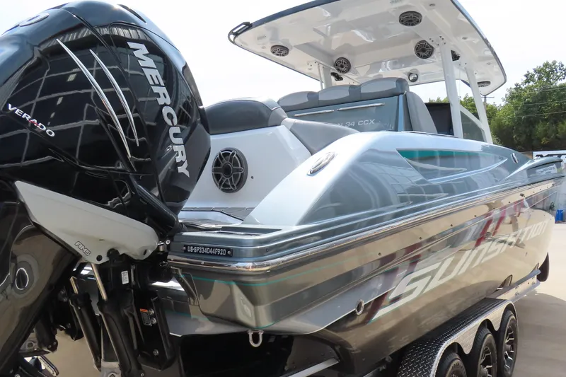 Slide: The Image of 2020 Sunsation 34 CCX boat with Mercury Verado engine, sleek design, and modern features. - 5