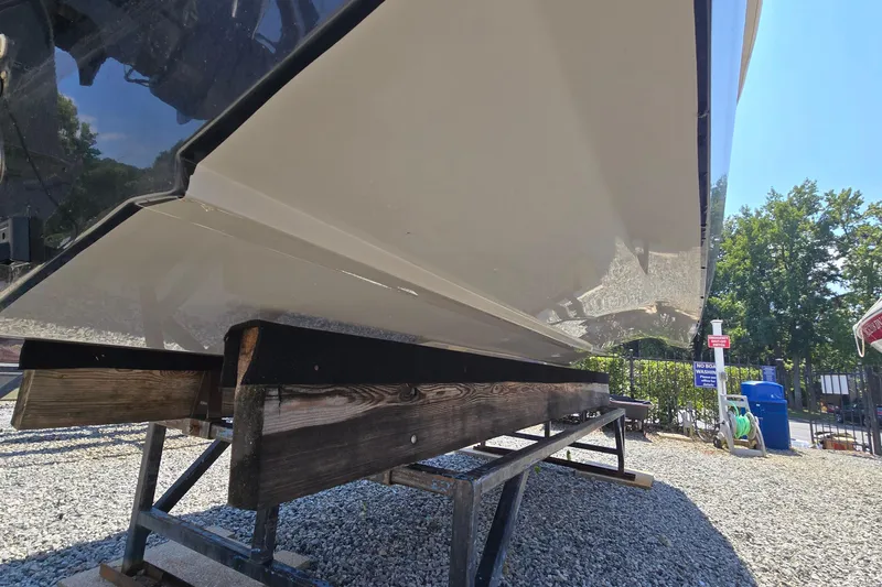 Slide: The Image of 2021 Starcraft SVX 191 OB boat on a wooden stand, outdoor setting. - 11