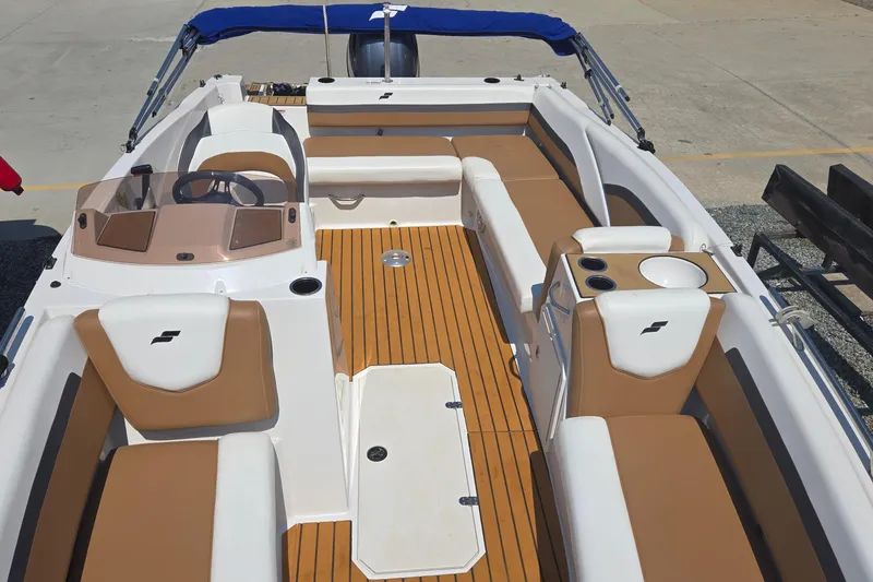 Slide: The Image of 2021 Starcraft SVX 191 OB boat interior with tan and white seating, wood-style flooring. - 14