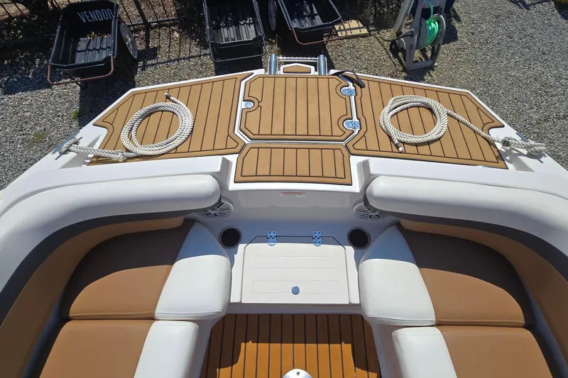 Slide: The Image of 2021 Starcraft SVX 191 OB boat interior with tan seating and wooden deck. - 16