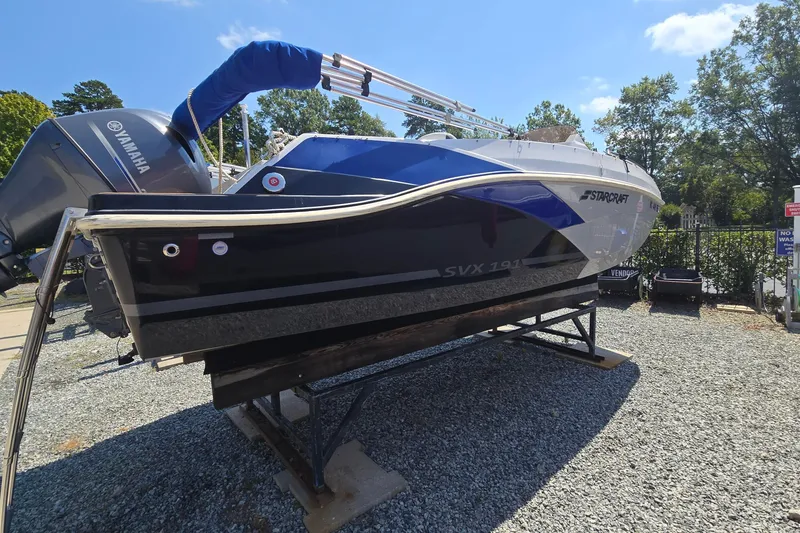 Slide: The Image of 2021 Starcraft SVX 191 OB boat with Yamaha engine on display outdoors. - 2