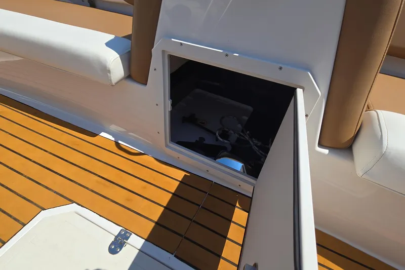 Slide: The Image of 2021 Starcraft SVX 191 OB boat storage compartment with open hatch on teak deck. - 20