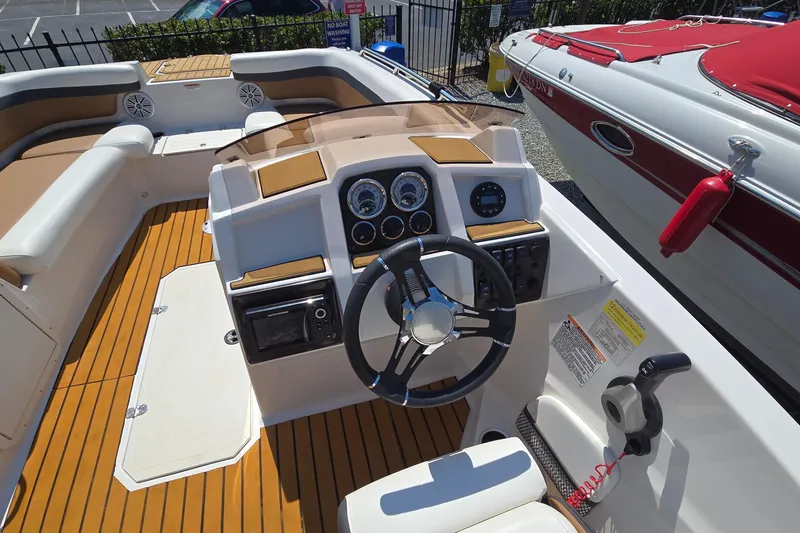 Slide: The Image of 2021 Starcraft SVX 191 OB boat interior with steering wheel and dashboard controls. - 25