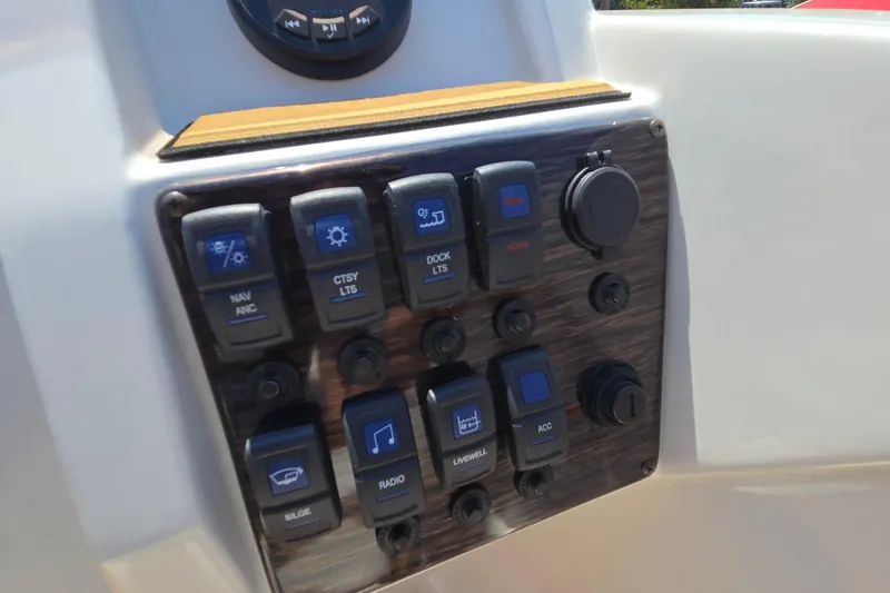 Slide: The Image of Control panel of 2021 Starcraft SVX 191 OB boat with various switches and dials. - 27
