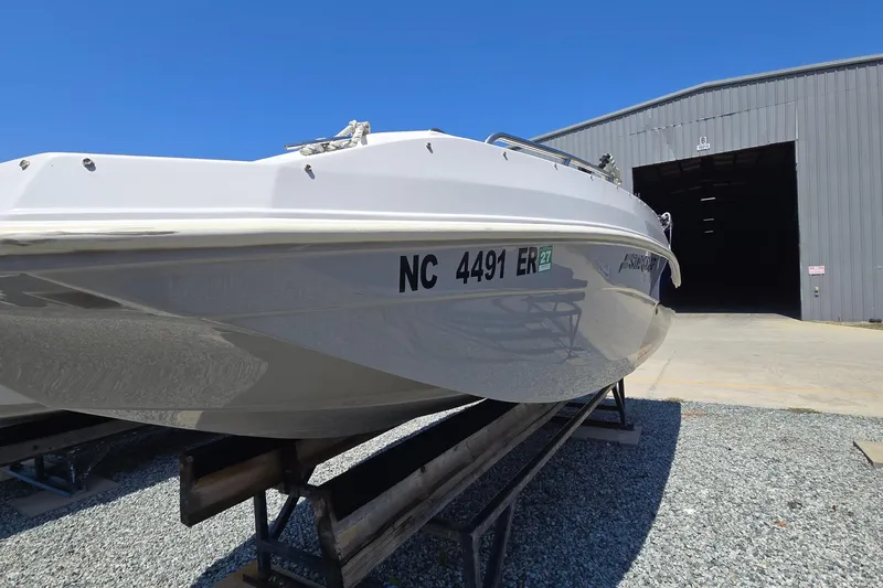 Slide: The Image of 2021 Starcraft SVX 191 OB boat on trailer outside a large warehouse. - 3