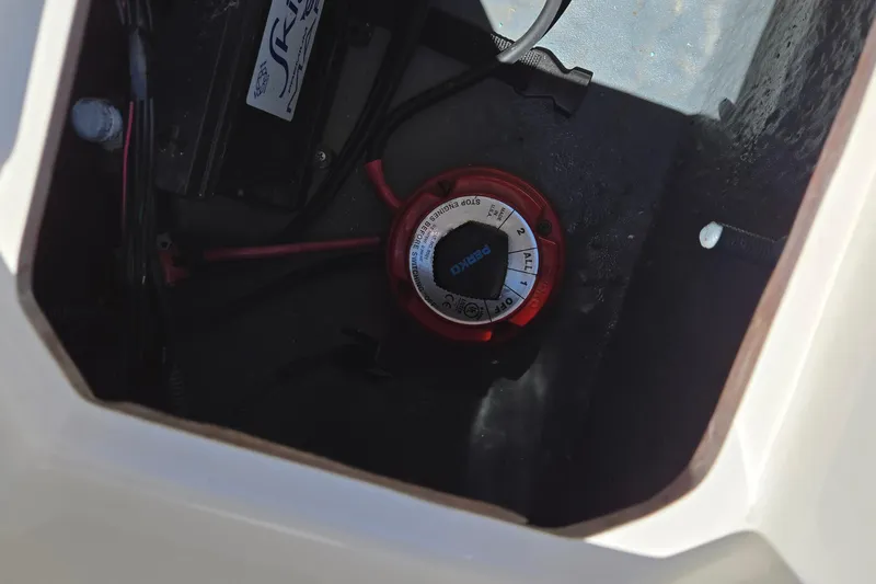 Slide: The Image of 2021 Starcraft SVX 191 OB battery compartment with Perko switch and wiring. - 32