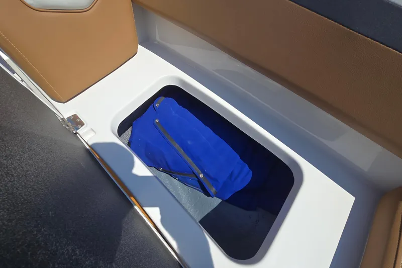 Slide: The Image of 2021 Starcraft SVX 191 OB boat storage compartment with blue cover inside. - 38